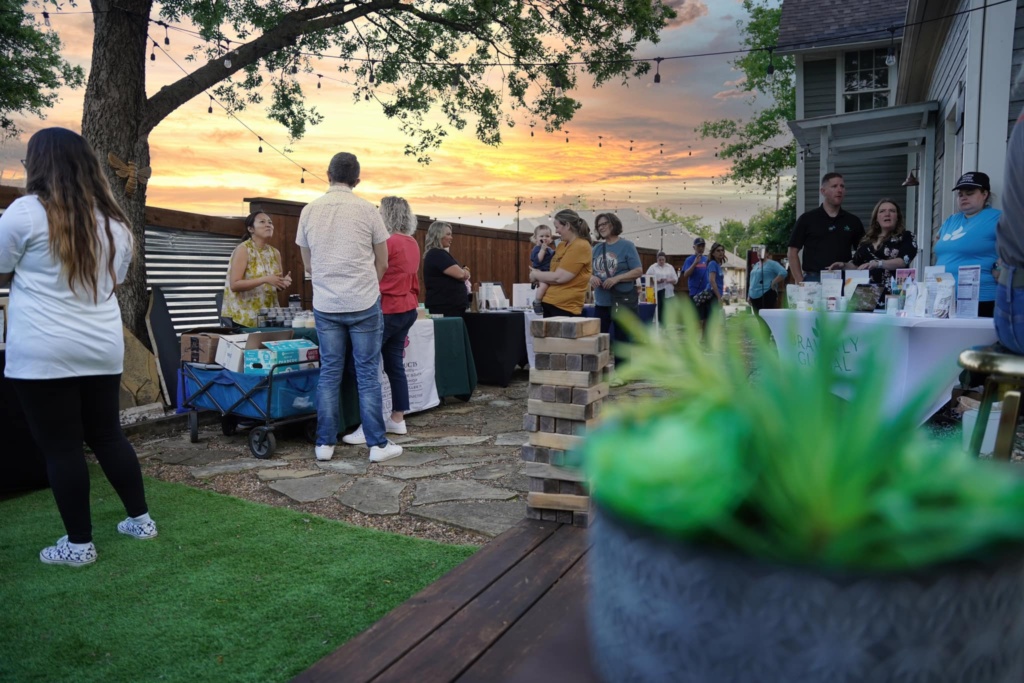 Guests shopping at vendor booths under string lights at 139 Olive Night Market in Old Town Keller