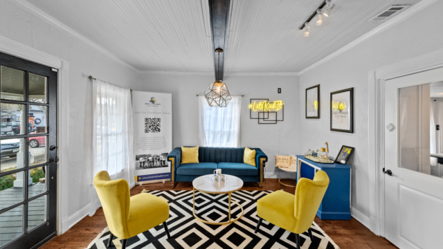 Indoor lounge with blue sofa and yellow chairs at 139 Olive