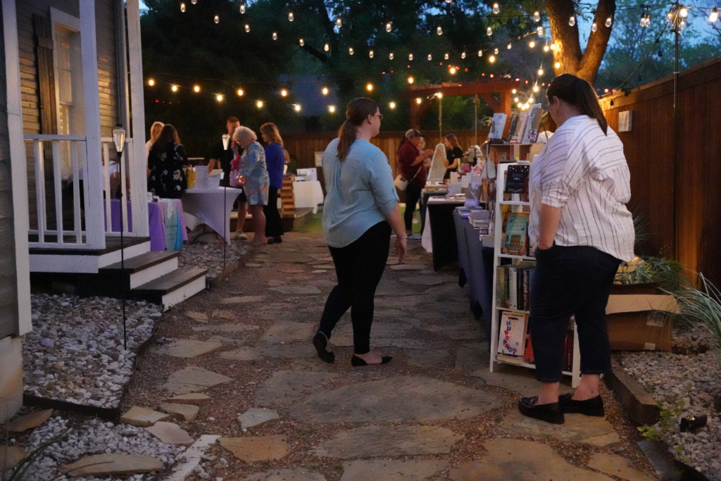Guests shopping at vendor booths under string lights at 139 Olive Night Market in Old Town Keller