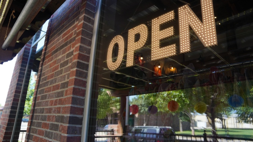 Illuminated OPEN sign in the window of a local business