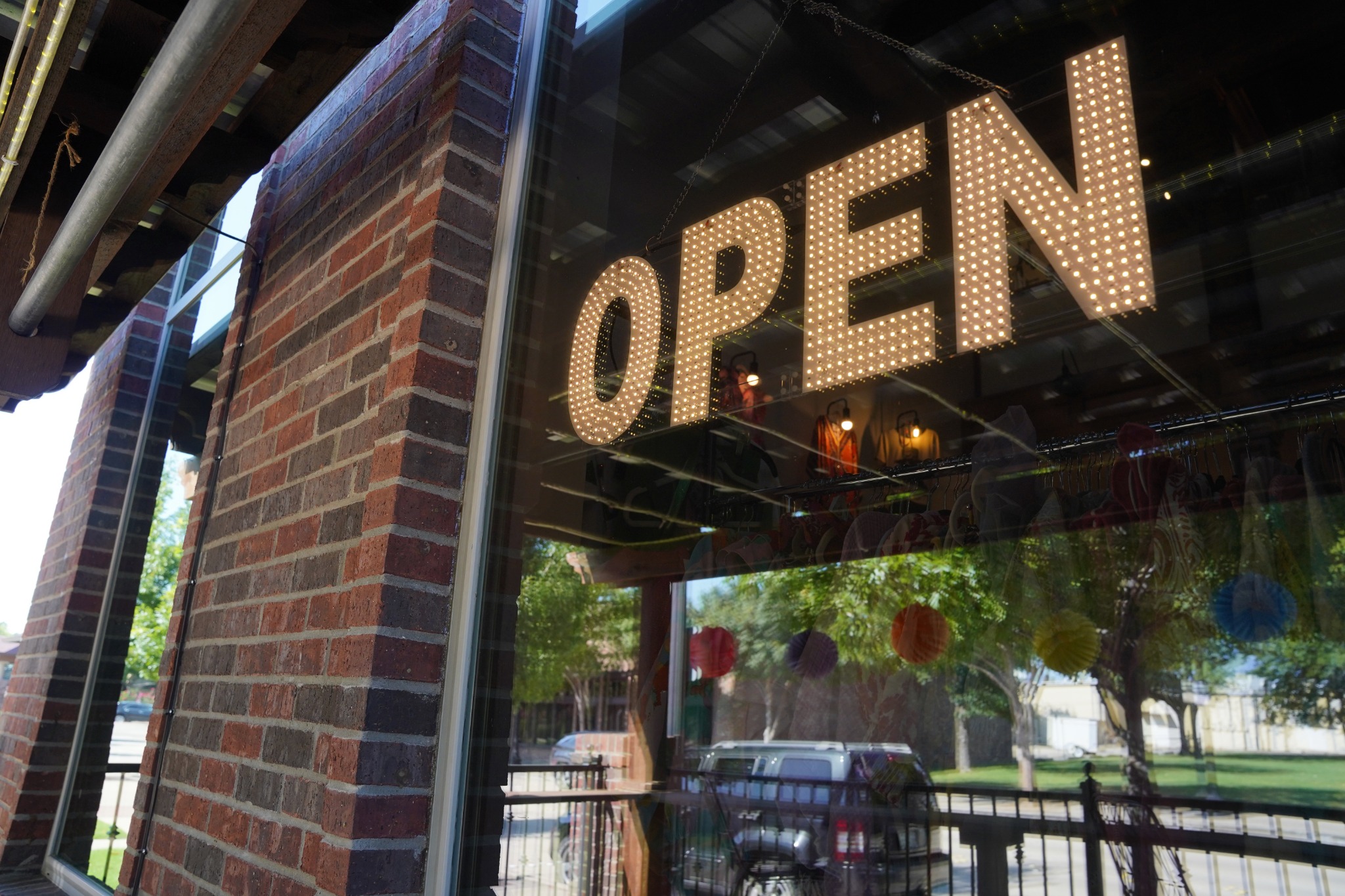 Illuminated OPEN sign in the window of a local business