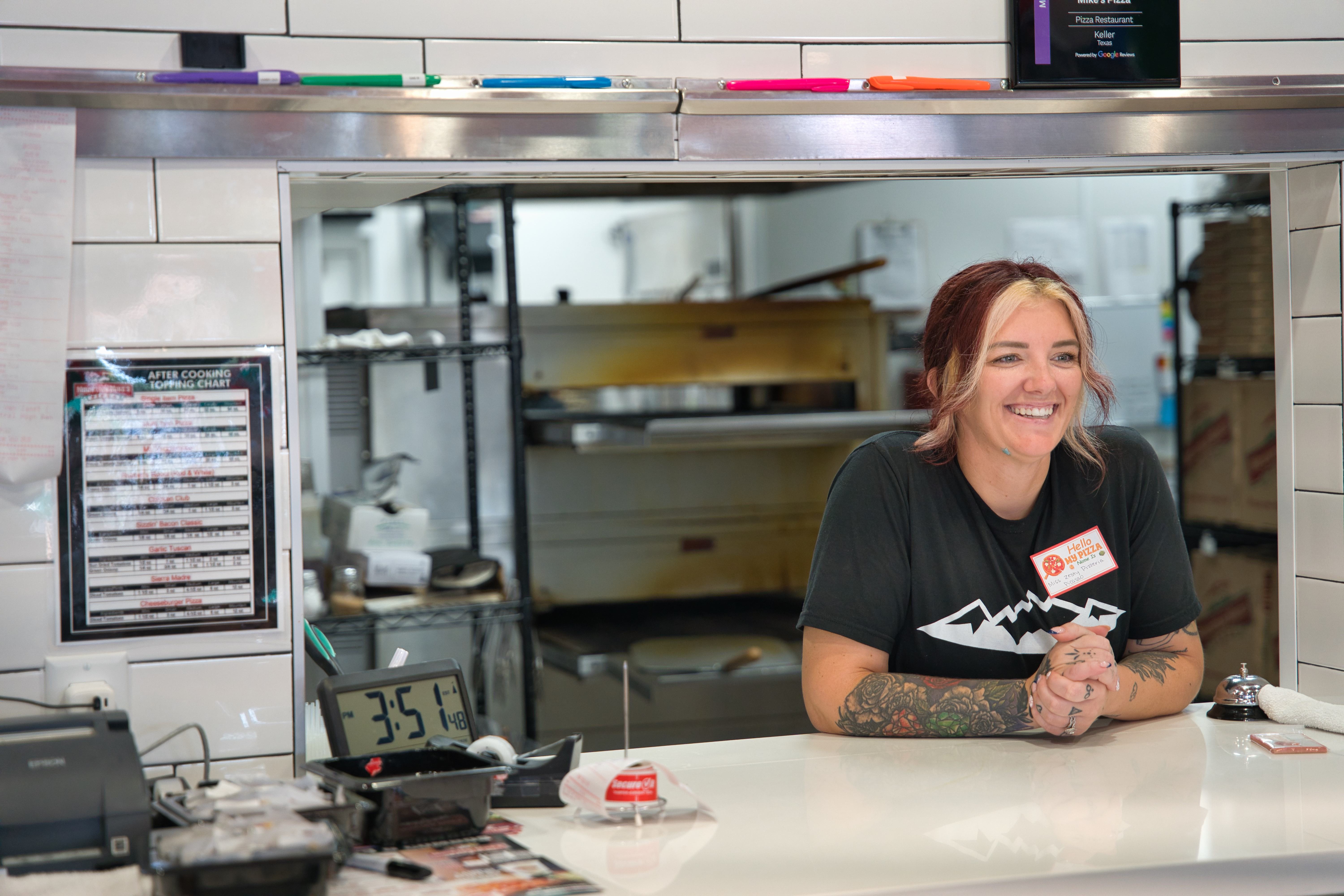 Mountain Mike’s Pizza Keller team member smiling behind the counter during the grand reopening
