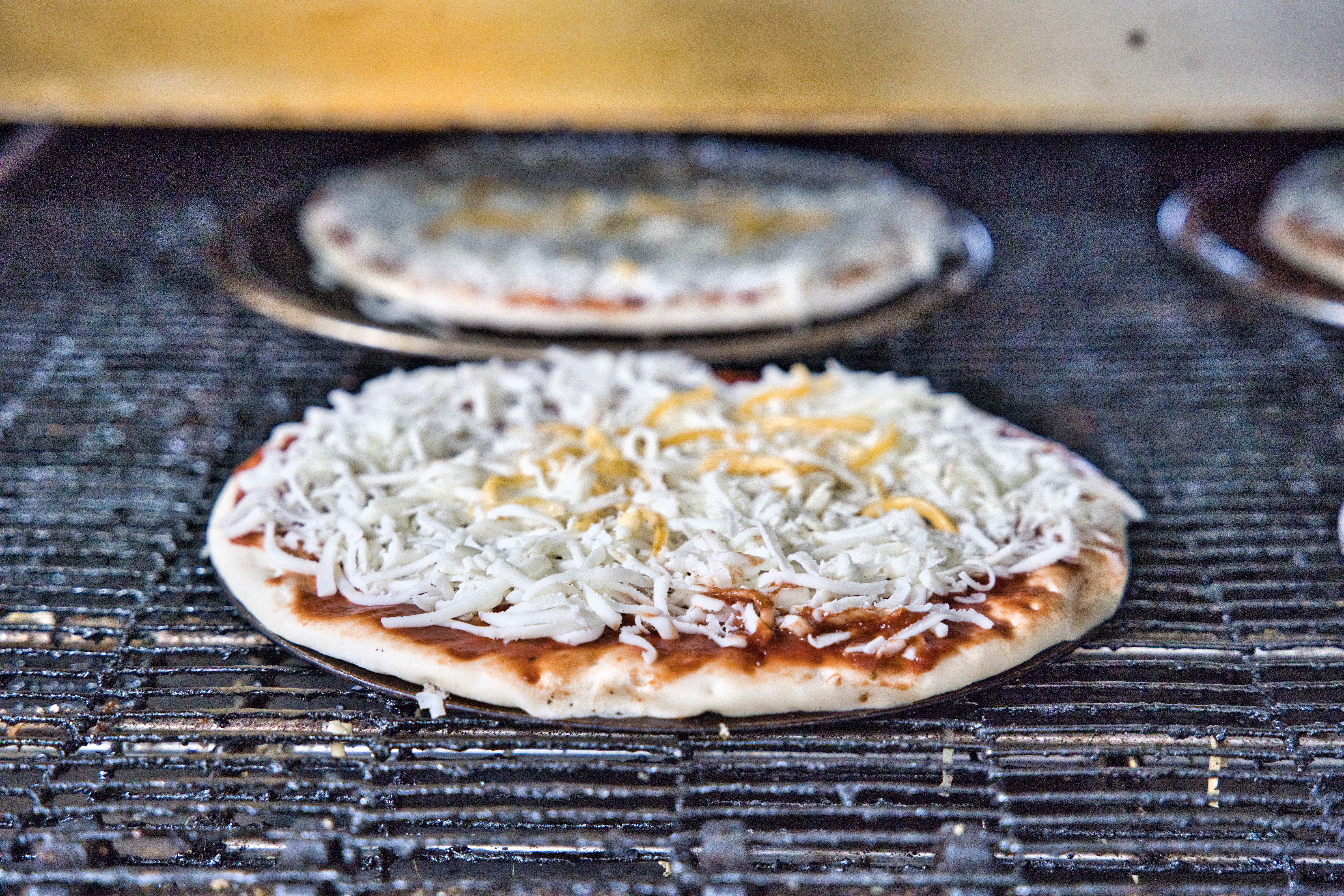 Fresh pizzas coming out of the oven at Mountain Mike’s Pizza in Keller
