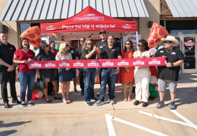Mountain Mike’s Pizza Keller owners, team and community partners cutting the ribbon at the grand reopening