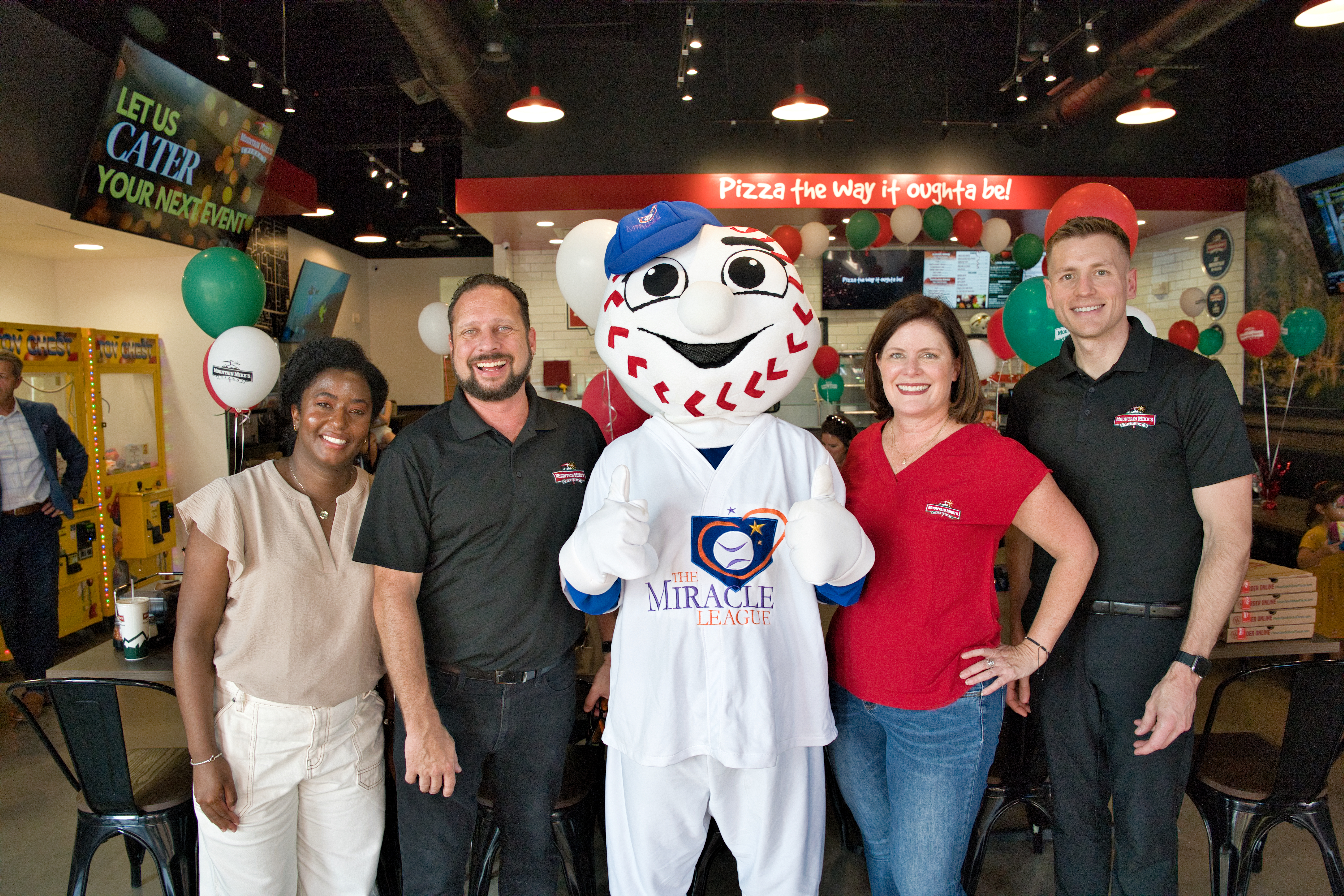 Homer from Miracle League of Keller with families and community members at Mountain Mike’s Pizza Keller grand reopening