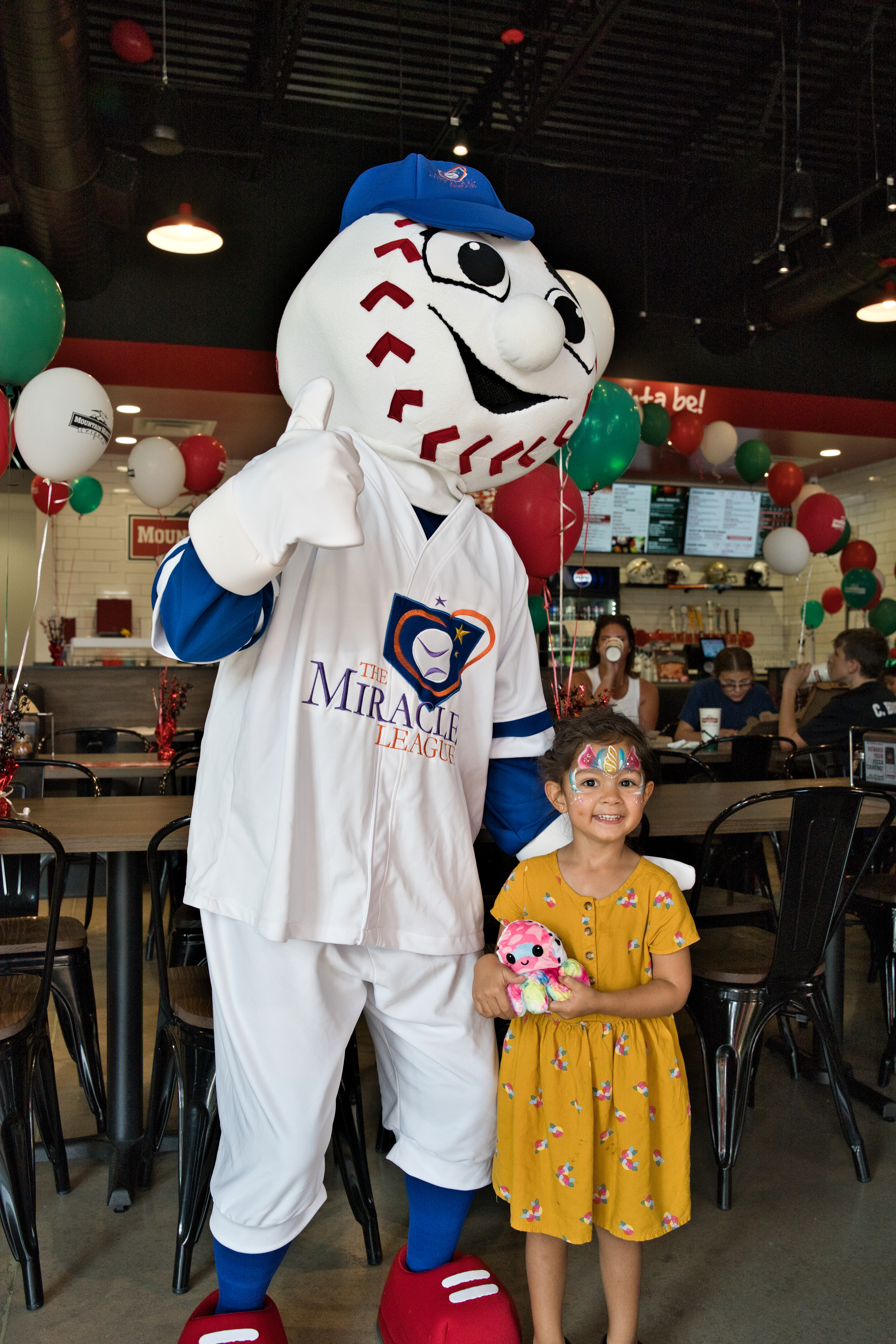 Homer with a family at the Mountain Mike’s Pizza Keller grand reopening supporting Miracle League