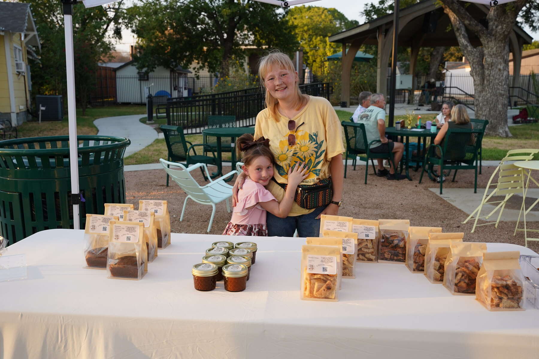 Baked goods, jars and a greeting from behind the table.