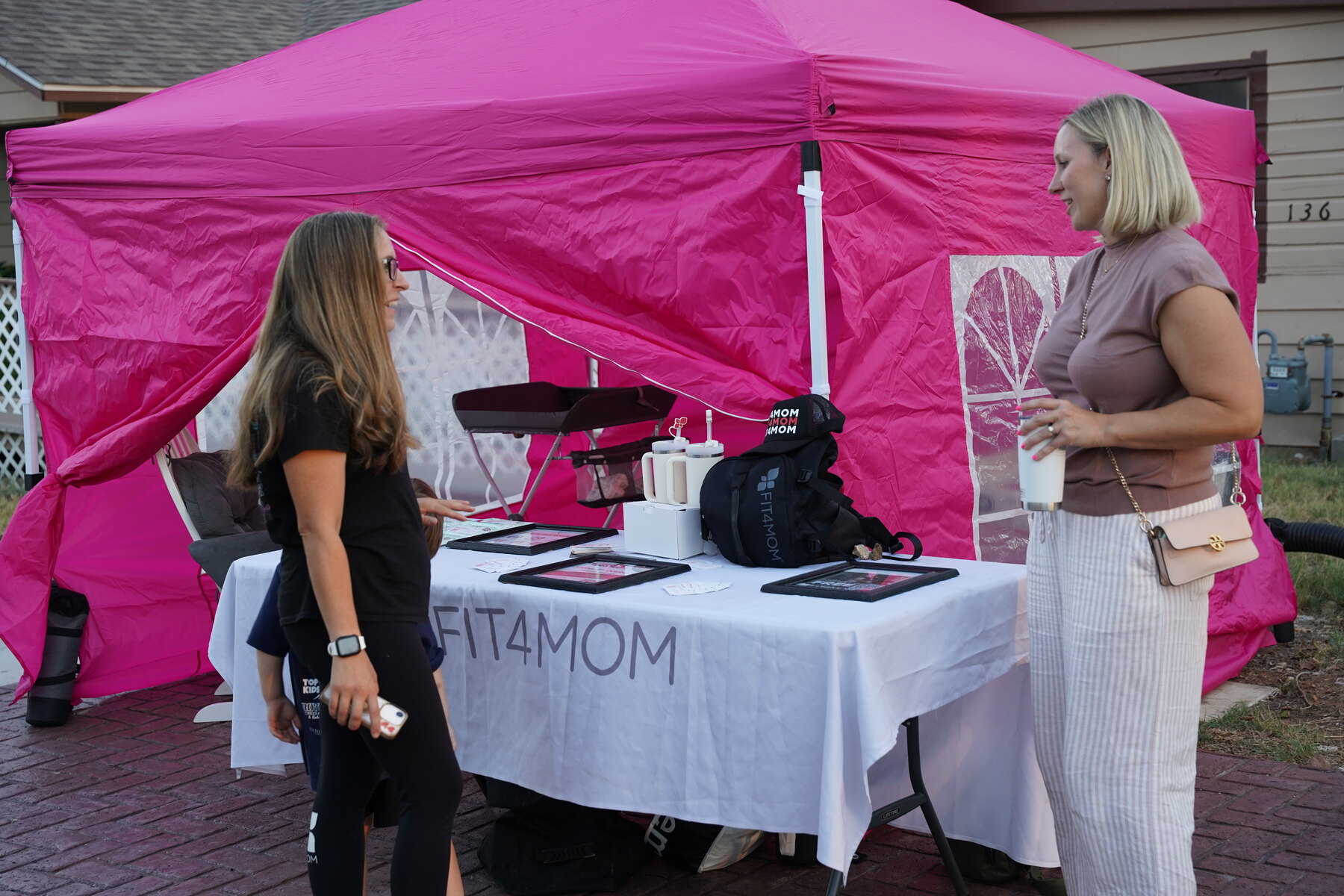 Making connections at the pink vendor tent.